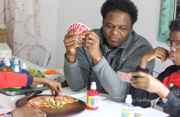 As kids grow older, they may not always want to do things with their parents. If you're struggling to find ways to engage your teens in game night, I'm sharing tips on engaging your teens. Family Game night is a great way to put down the devices and engage the whole family into connecting with each other.