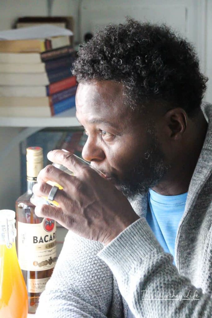 a man sipping on a cocktail Spicy Rum Apple Cider