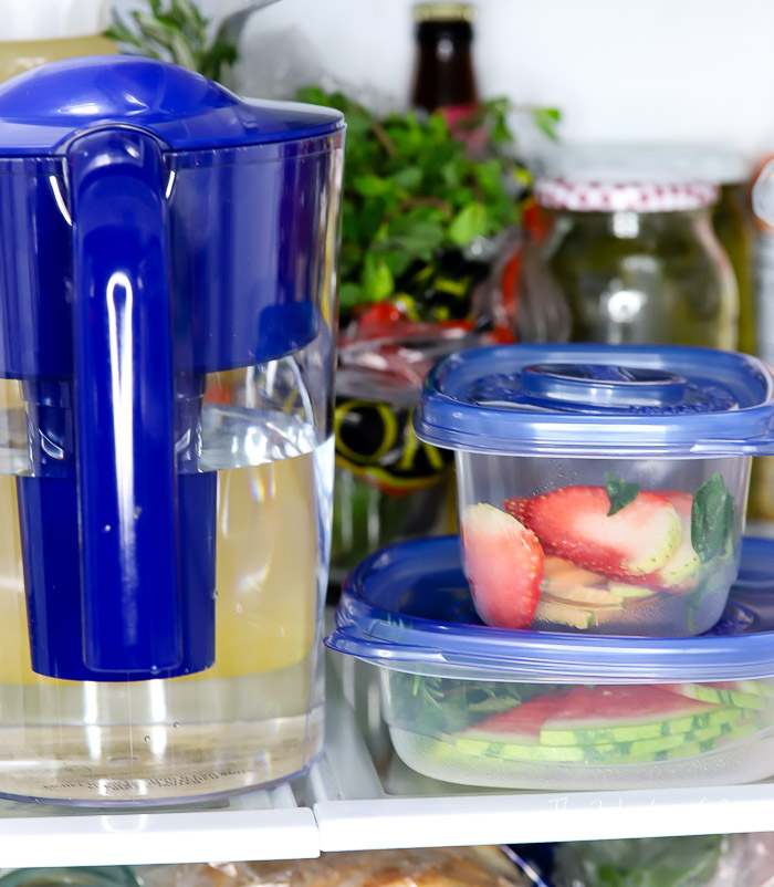 Brita Pitcher in fridge next to container with snacks