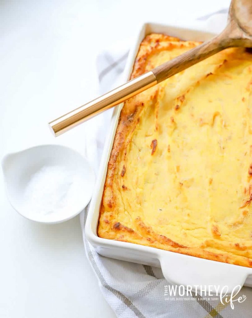 a baked butternut squash recipe in a casserole dish with salt in a small bowl