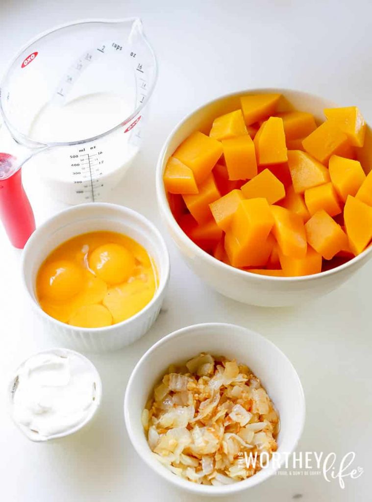 eggs, milk, sauted onions and cut up squash in a bowl