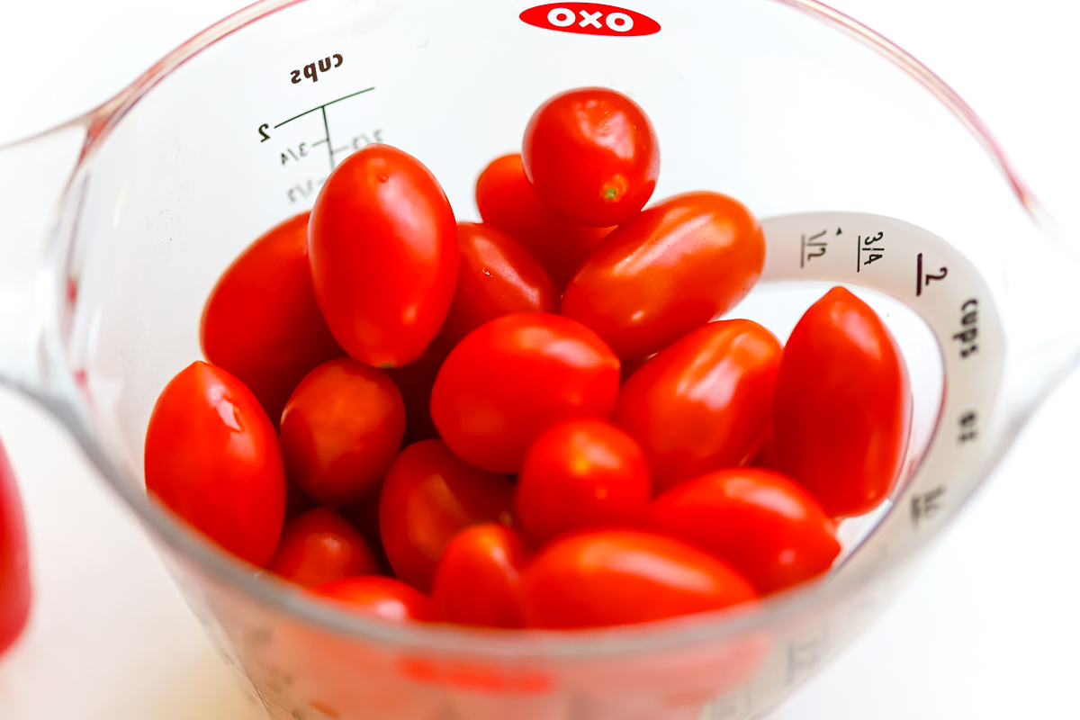fresh tomatoes in a measuring cup