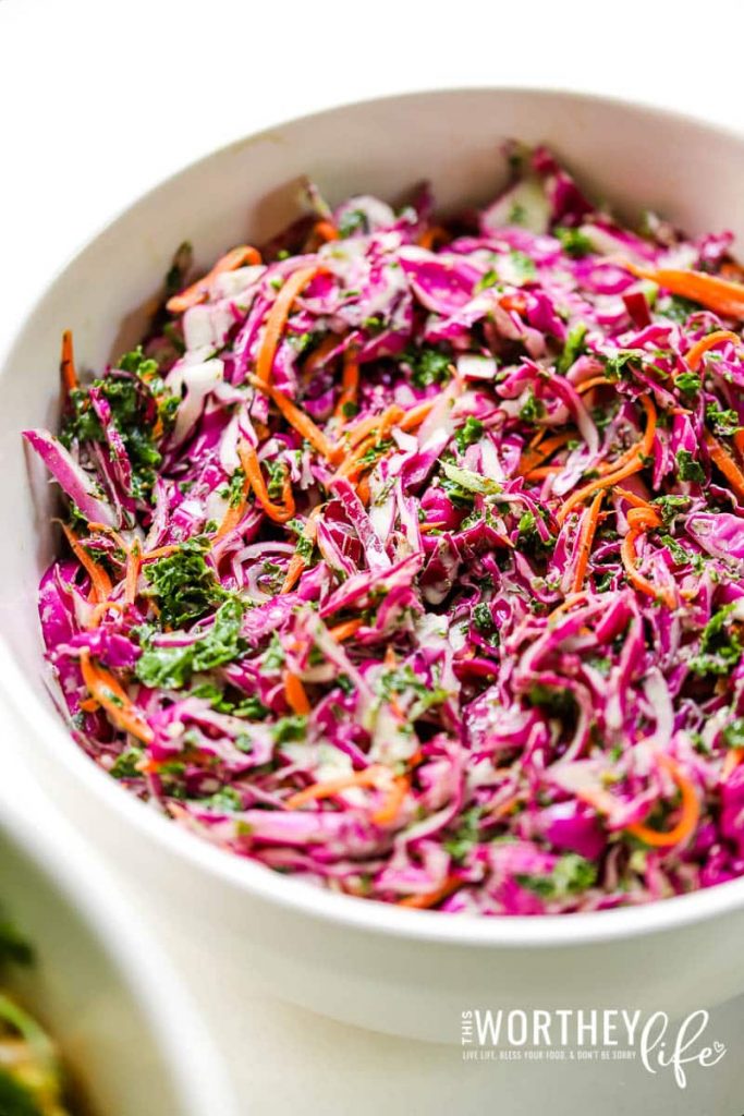 lemon herb aioli coleslaw in a white mixing bowl