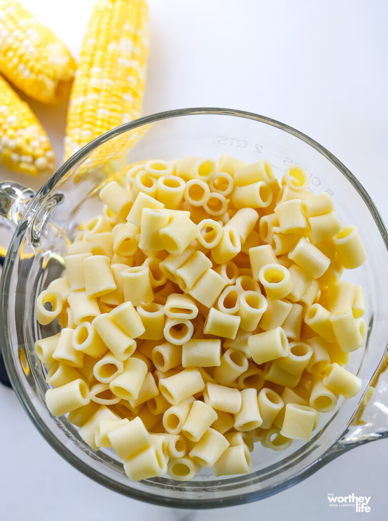cooked pasta noodles in a measuring bowl