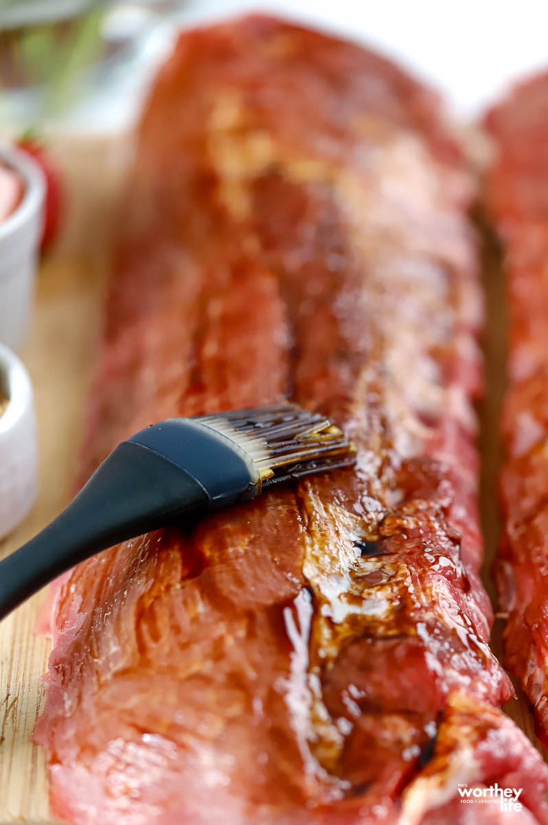 brushing baby back ribs with Balsamic glaze