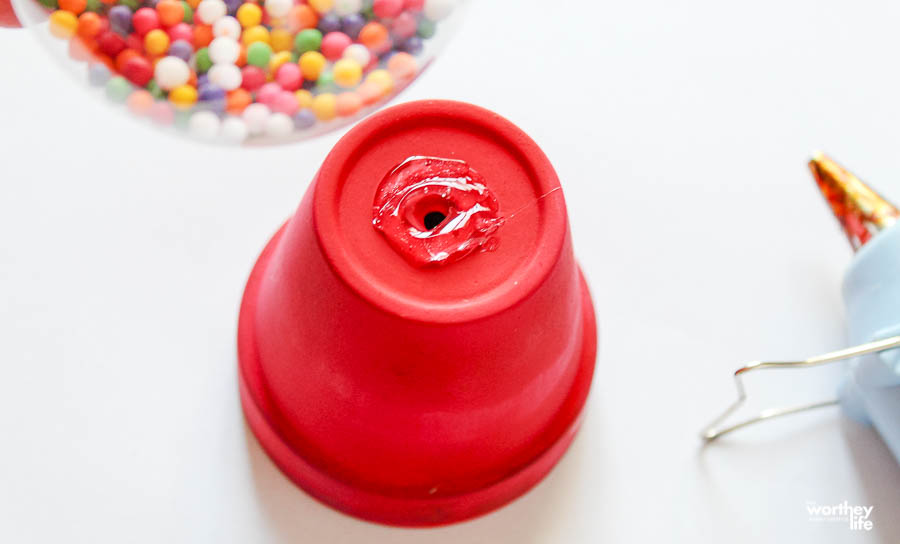 Adding glue to the base of the terra cotta planter