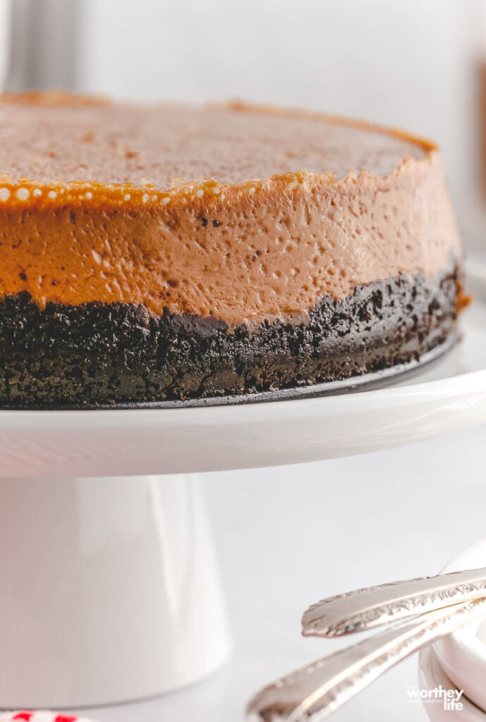 cheesecake with oreos on white stand