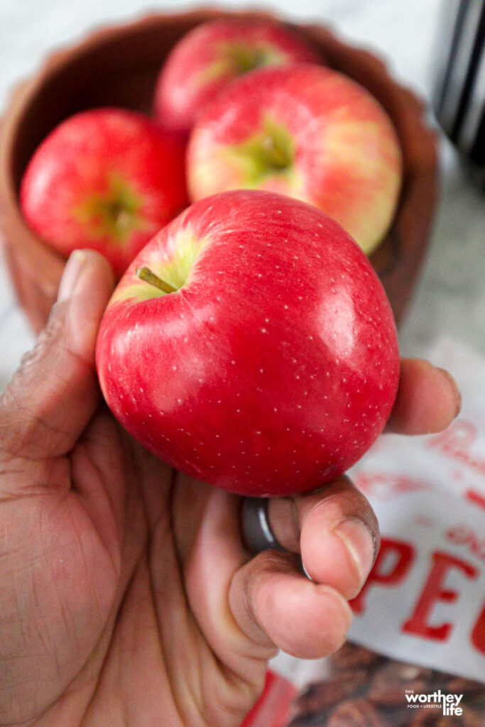 a man holding a red delicious apple