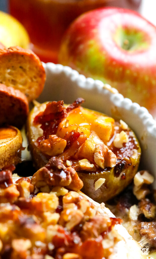 2 rounds of brie 1-2 apples peeled, cored, and chopped 2 tbsp of lemon juice 1 tbsp of cinnamon sugar&nbsp; 2 tbsp of unsalted butter 2 tbsp of water 2 pears but in half 1/2 cup chopped walnuts&nbsp; 2 slices thick-cut bacon, cooked until crispy and crumbled honey&nbsp; Directions: Preheat oven to 350 degrees. Peel and core the apples, then cut them into small cubes. Add the apples to a bowl and add the lemon juice and cinnamon sugar; toss the apples to evenly coat.&nbsp; Cut the pears in half, remove the core, brush them with lemon juice, and dust them with sugar cinnamon.&nbsp; Place a skillet over medium-high heat and add the 2 tablespoons of butter; when the butter is melted, add the apples and two tablespoons of water, and stir; reduce the heat to low and cook until the apples are soft for about 7 to 8 minutes. Using a slotted spoon, transfer the apples to a small bowl and set aside. Adjust the heat to medium-high and place the pears cut-side down into the skillet. Cook for 2 minutes, then adjust the heat to low and cook for 7 to 8 minutes until the pears are soft but not mushy.&nbsp; Using a slotted spoon, transfer the pears to a place cut-side up, and set them aside.&nbsp; Place the brie into the skillet, then add the apples on top. Put the skillet into the oven on the middle rack and bake for 15 to 20 minutes.&nbsp; Remove the brie from the oven and add the pears, crumbled bacon, and chopped nuts.&nbsp; Drizzle with honey.&nbsp; Serve with crusty bread, bagel chips, Biscoff cookies, or crackers.&nbsp;