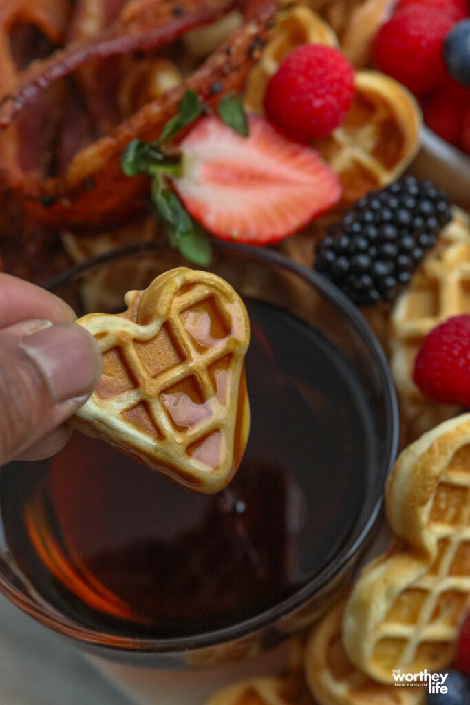 dipping a waffle into syrup