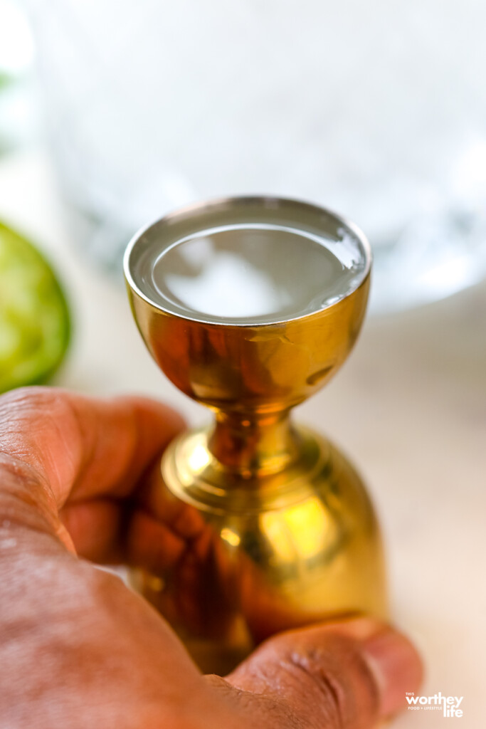 man holding a gold jigger