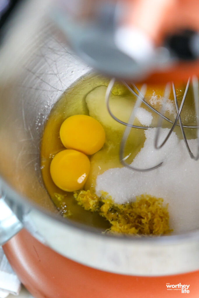 adding farm fresh eggs to a stand mixer