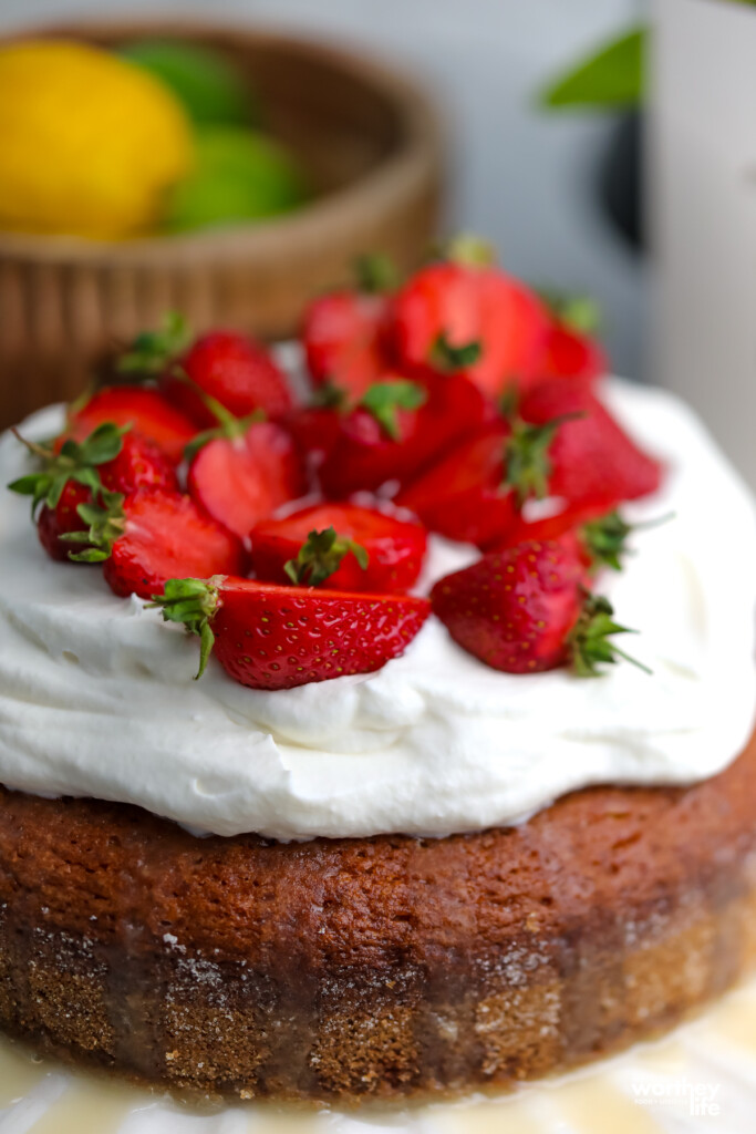 fresh strawberries and whipped cream on a cake
