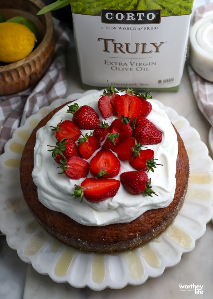 a lemon olive oil cake next to a corto brand olive oil