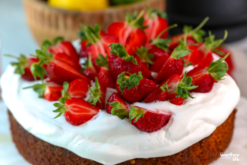 a lemon olive oil cake topped with fresh strawberries