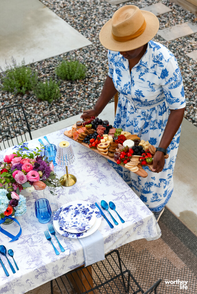 woman putting a charcuterie board on table