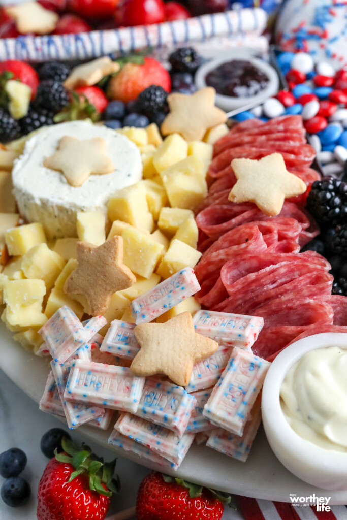adding meats to a charcuterie board