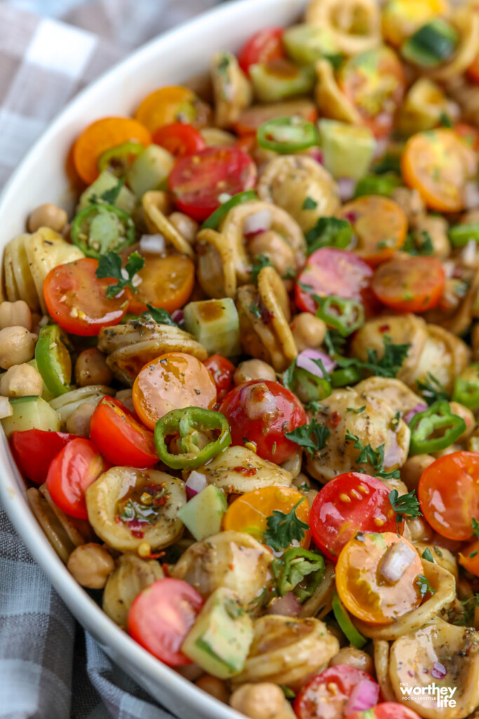 mixing ingredients together for a pasta salad