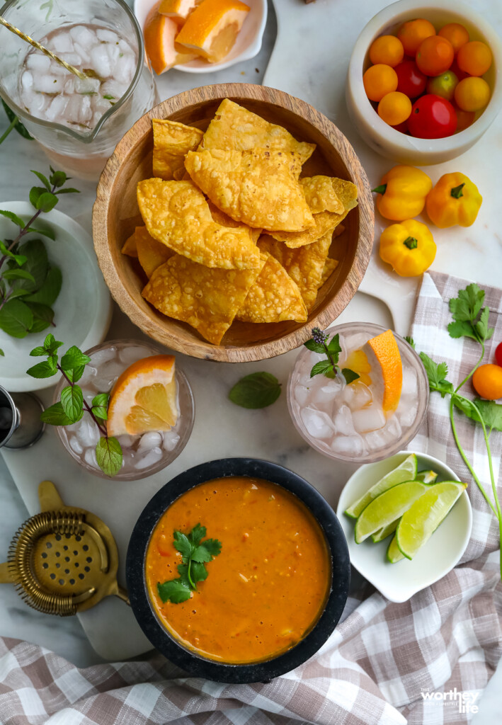 fresh homemade salsa with tortilla chips and a cocktail