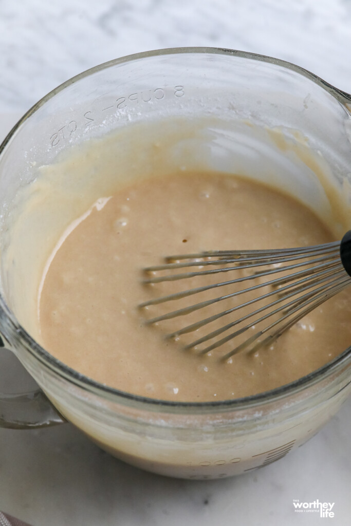apple cider donut batter in a glass mixing bowl