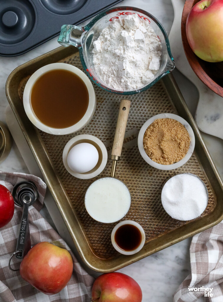 ingredients for making apple cider donuts on a baking tray