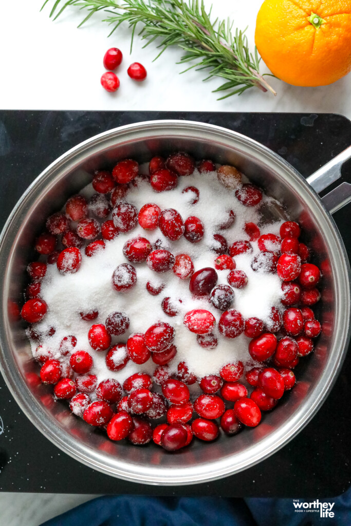 sugar and cranberries in a sauce pan