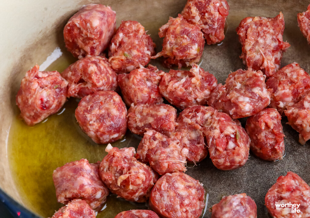  cooking sausage in a dutch oven