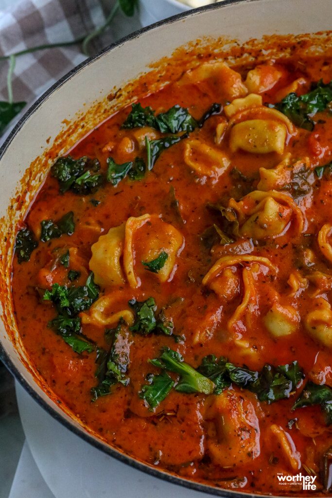 Tortellini Soup with Kale in a blue dutch oven