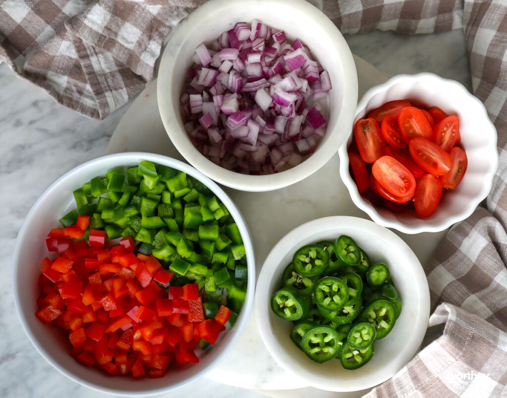 toppings for nachos in white bowls