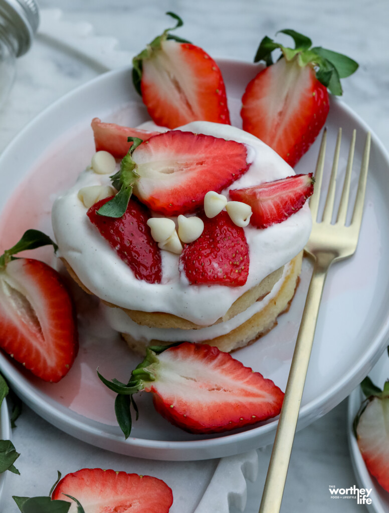 fresh strawberries with mini pancakes and strawberry syrup and homemade whipped cream