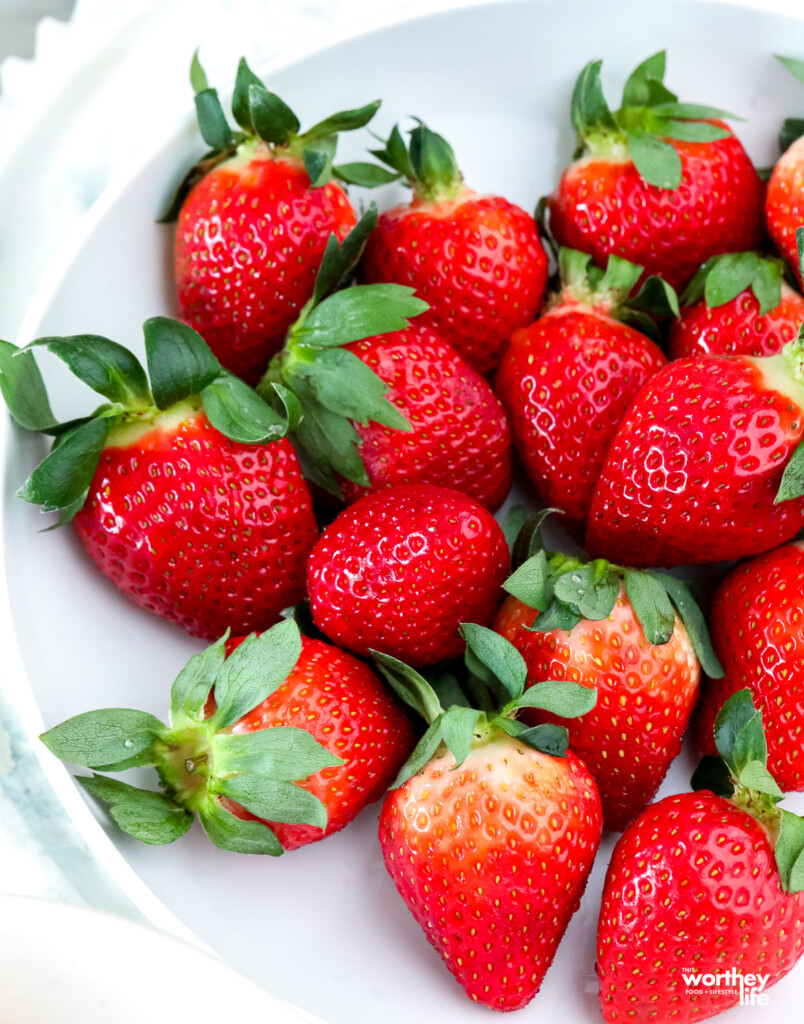 fresh juicy strawberries on a white plate