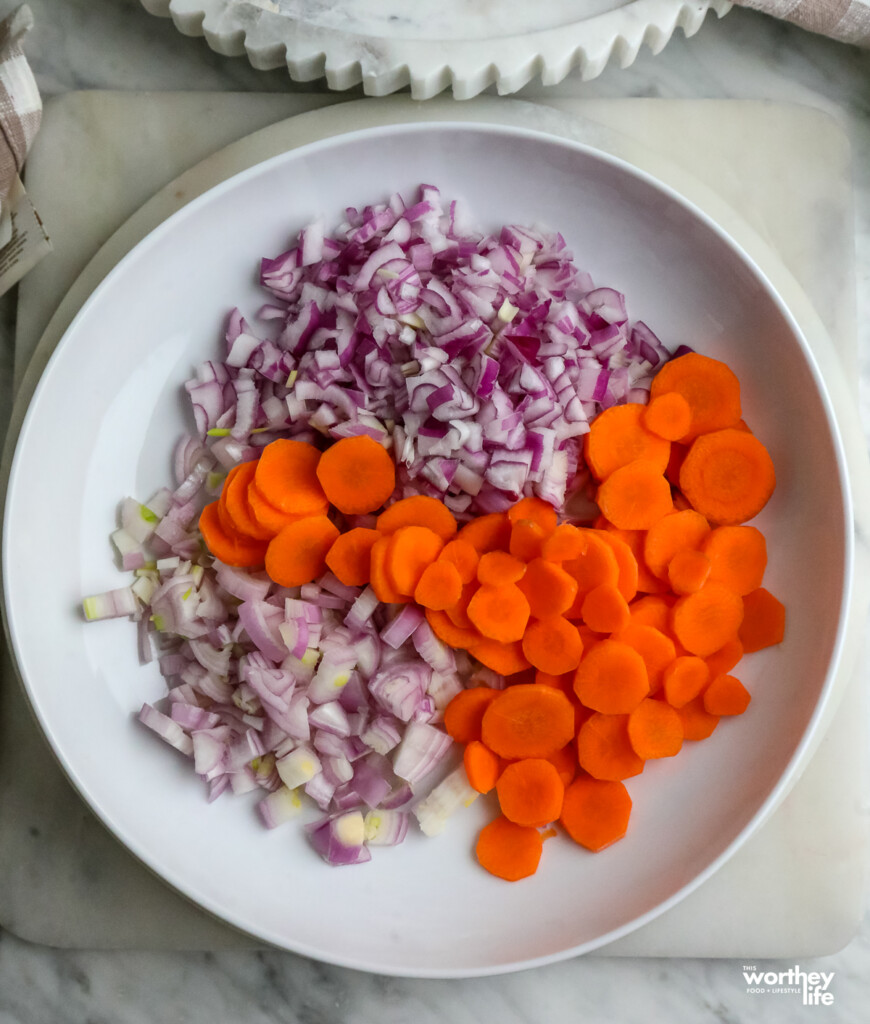 a plate of shallots, onions and carrots minced