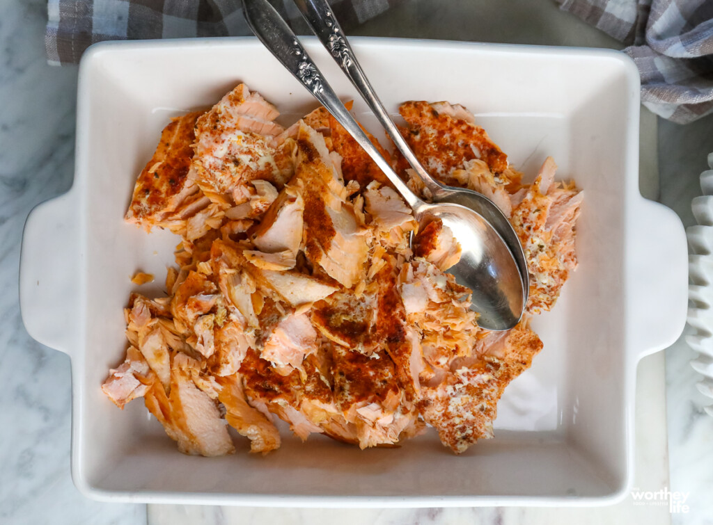 salmon cut up in a pan