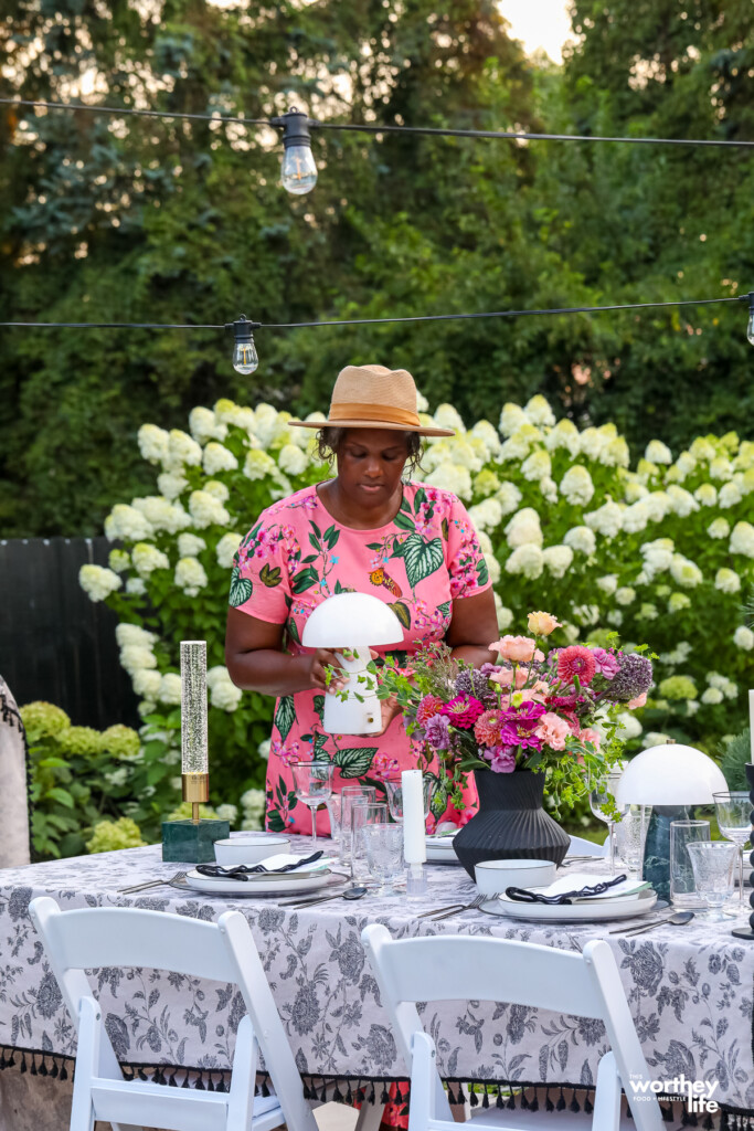 a woman holding a marble portable lamp to sit on a table