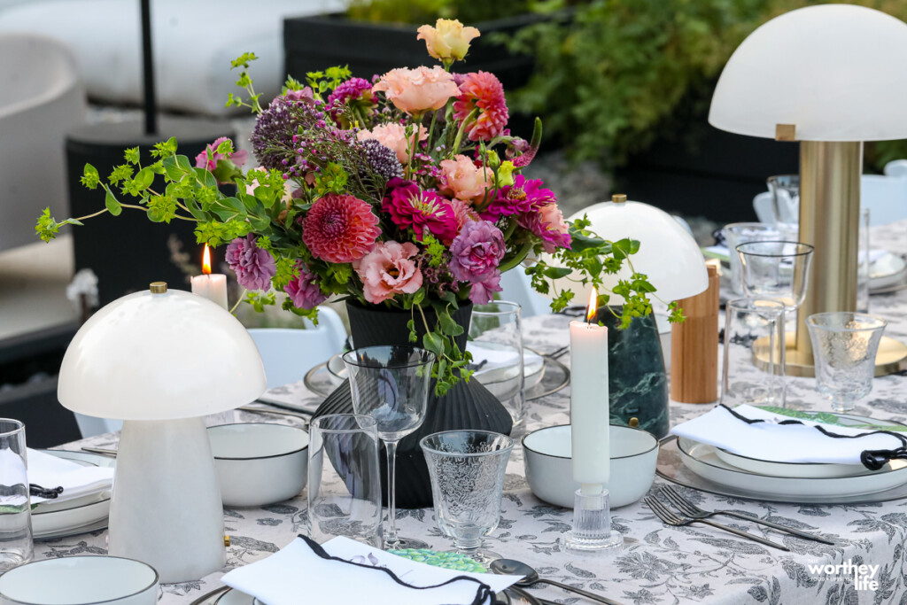 summer tablescape centerpiece with lamps, flowers and candles