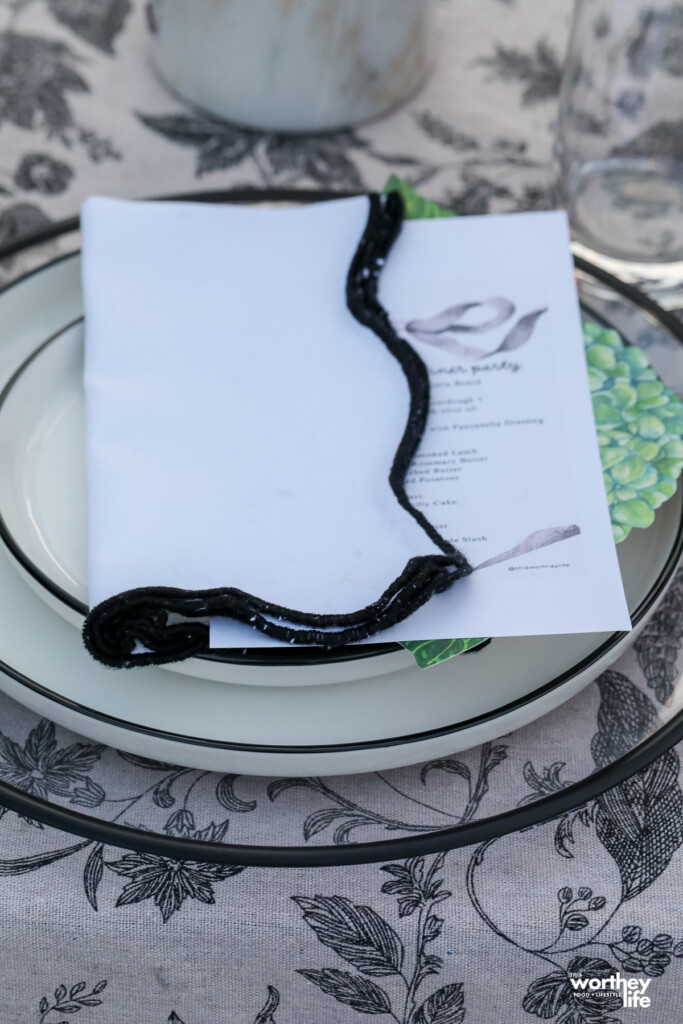 table setting with white plates with black trim