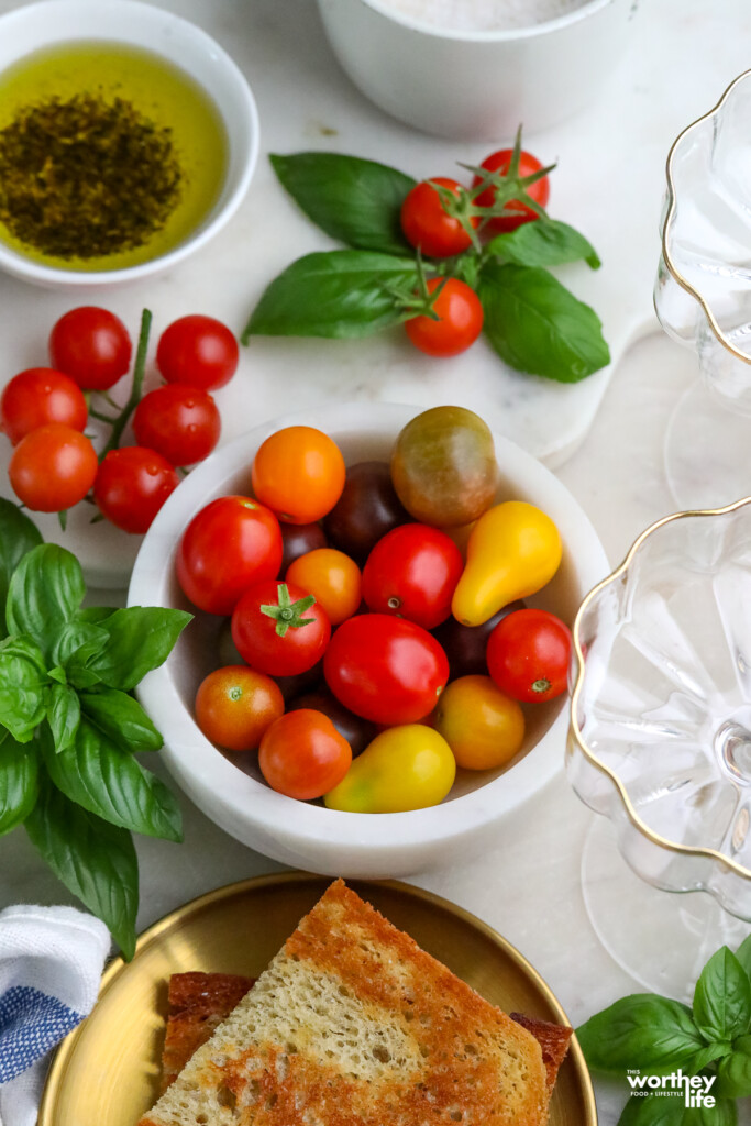a bowl of cherry tomatoes with sourdough bread