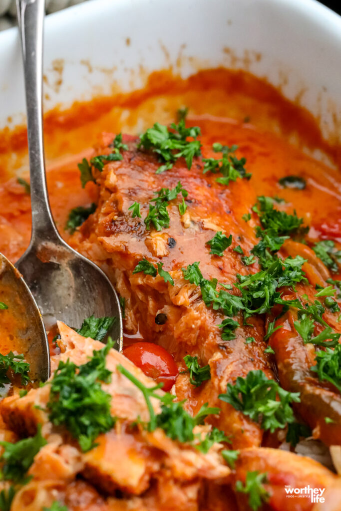 a creamy tomato sauced based with salmon in a white baking dish