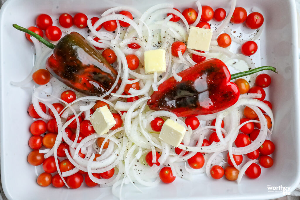 onions, tomatoes, peppers in a pan to roast