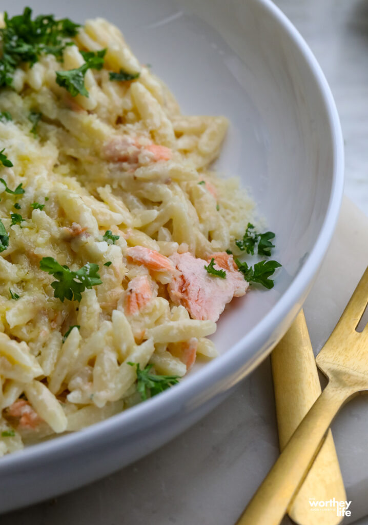 creamy salmon orzo pasta on a white plate